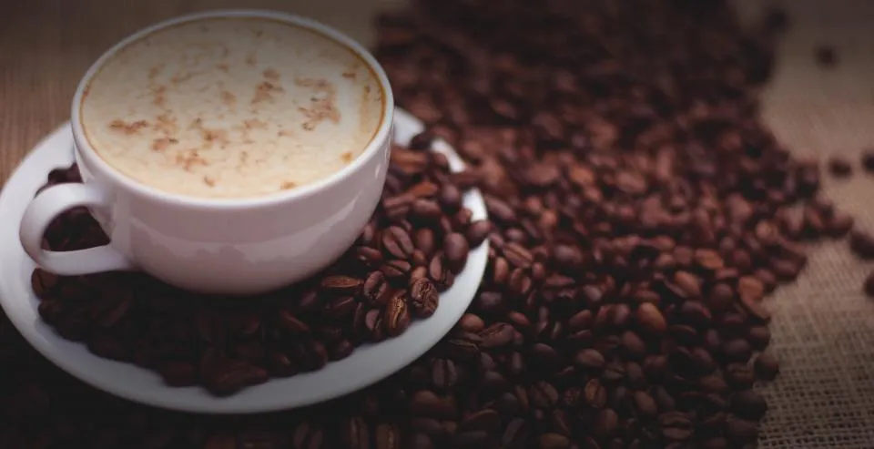 Cappuccino and coffee beans
