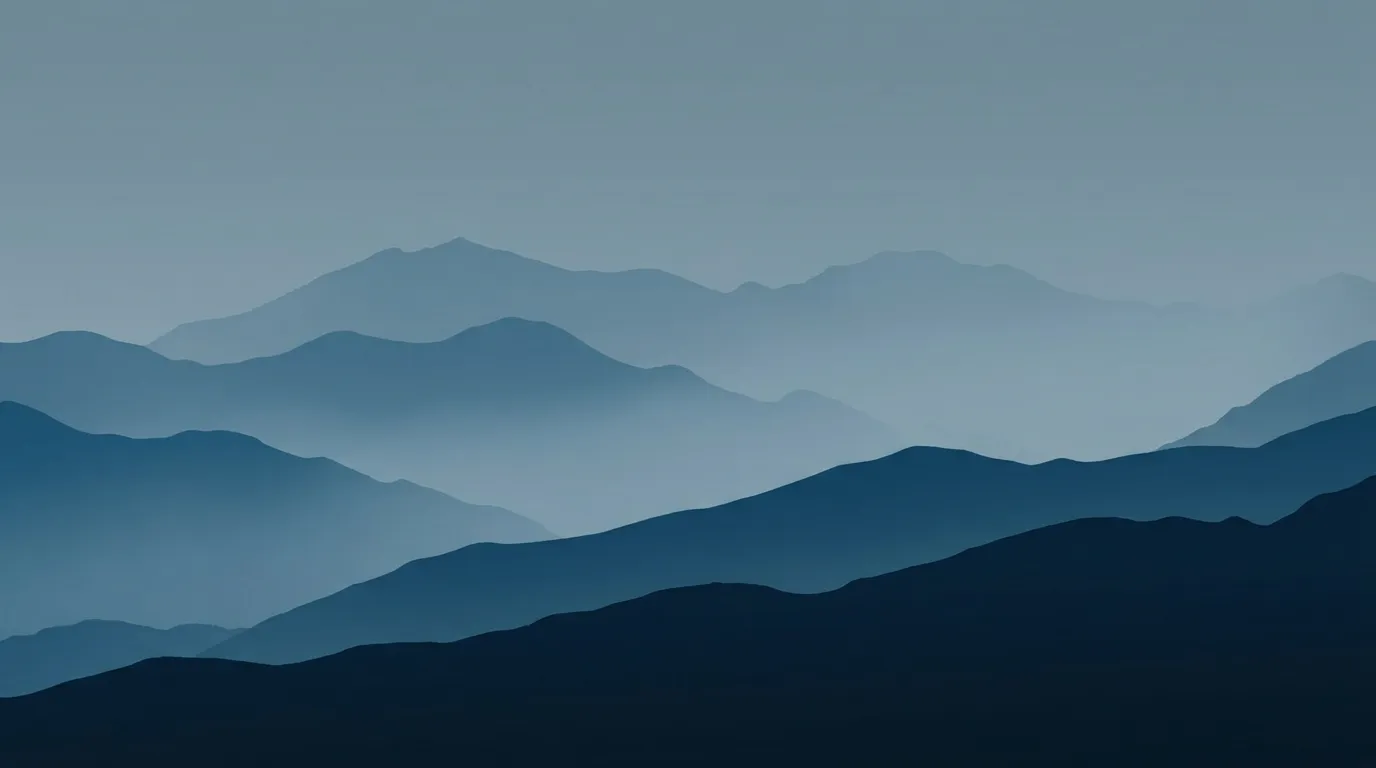 Layered blue mountains in the mist