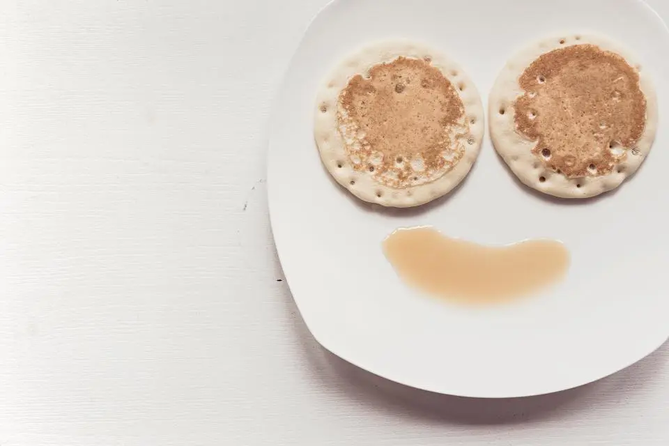 Smiley face pancakes with syrup