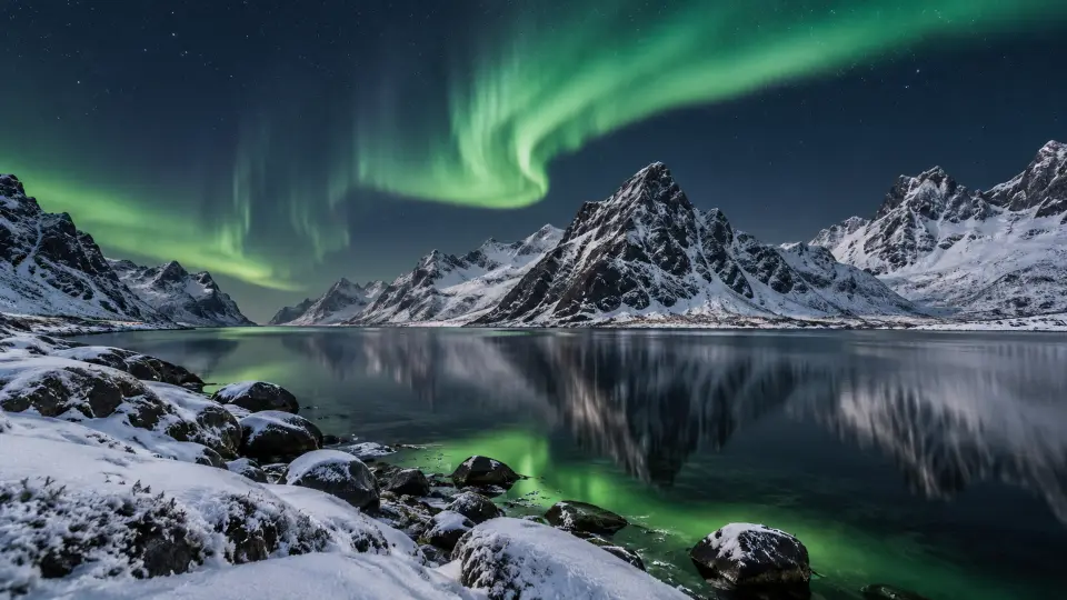 Northern lights over snowy mountains