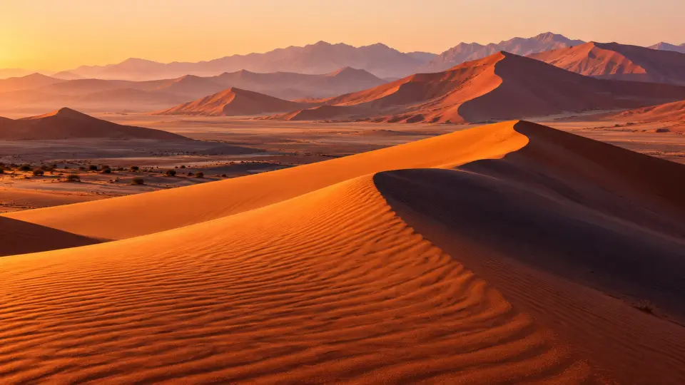 Orange sand dunes at sunrise