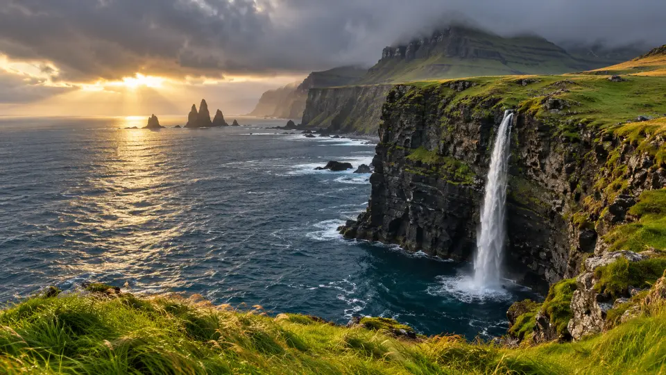 Waterfall plunging off sea cliffs at sunset